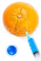 Syringe injecting blue liquid in an orange