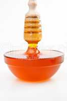 Honey trickle vertically dropping in full honey bowl