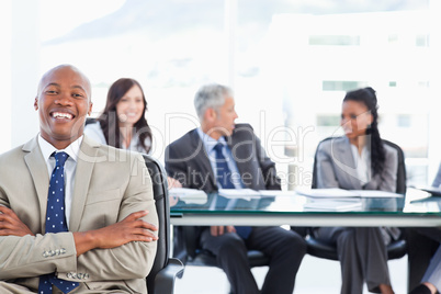 Young executive crossing his arms while laughing in front of the