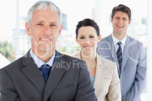 Young smiling executive woman wearing a formal suit between two