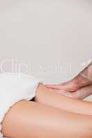 Woman being massaged her thigh by a masseur