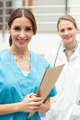 Nurse standing in a hospital reception with a doctor