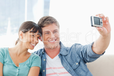 A smiling couple pose for a romantic photo together