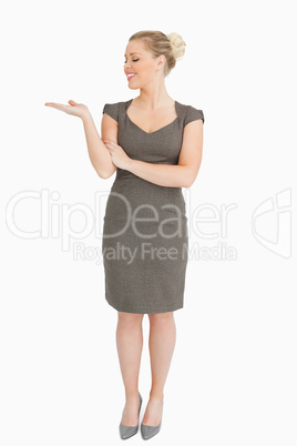 Woman looking her hand presenting something