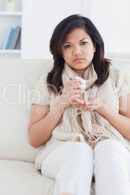 Sick woman sitting on a couch
