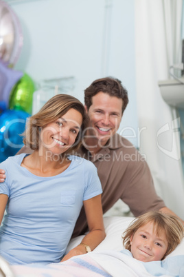 Child on a medical bed next to his parents