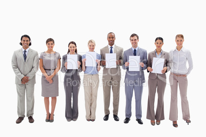 Happy business people holding five supports for letters