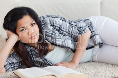 Woman on the floor holding her head with her hand