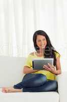 Beautiful Latino smiling while using a touch pad
