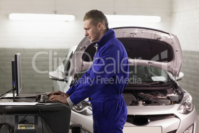 Concentrated mechanic looking at a computer