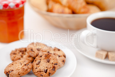 Cookies and a cup of coffee on white plates with sugar croissant