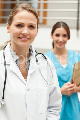 Doctor standing in a hospital reception with a nurse