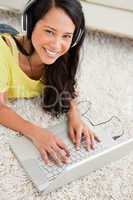 Portrait of a smiling Latin chatting on a laptop