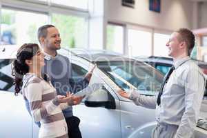 Couple chatting with a salesman