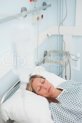Woman lying on a medical bed while closing her eyes