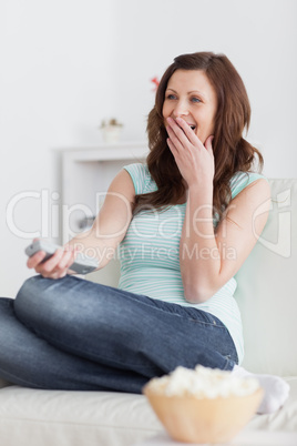 Woman sitting on a sofa while laughing