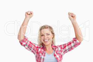 Cheerful blonde woman raising her two fists