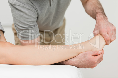 Physiotherapist stretching the ankle of a patient