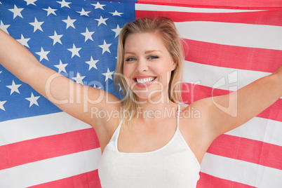 Smiling woman raising the American flag