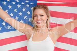 Smiling woman raising the American flag