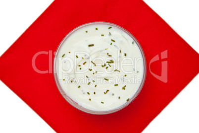 Bowl of dip with herbs on a red napkin