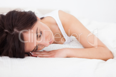 Tired woman resting while lying on her blanket