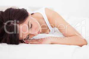 Tired woman resting while lying on her blanket