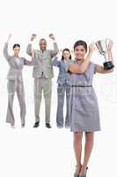 Woman holding up a cup with happy co-workers