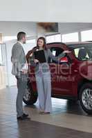 Businesswoman showing a car