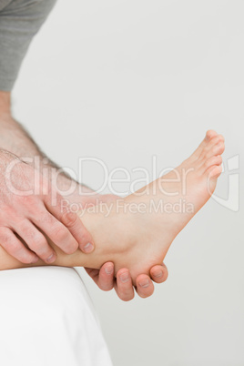 Ball of a foot being held by a practitioner
