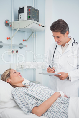 Doctor standing while holding a chart