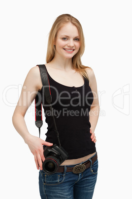 Woman smiling while carrying a camera