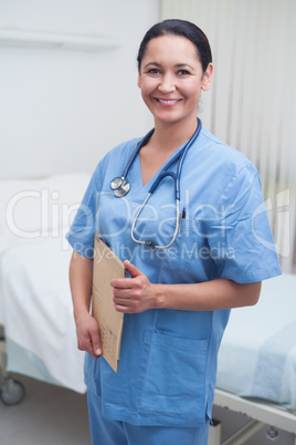 Smiling nurse holding a medical chart
