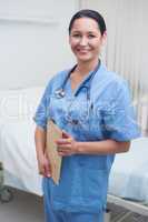 Smiling nurse holding a medical chart