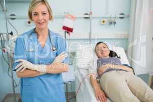 Nurse standing next to a female transfused patient