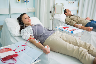 Two transfused patients lying on a bed