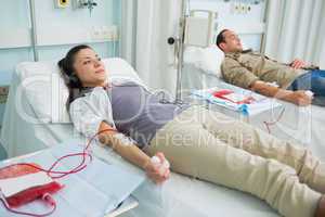 Two transfused patients lying on a bed