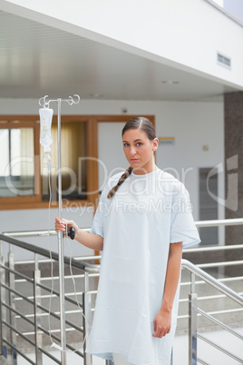 Female patient holding a drip stand