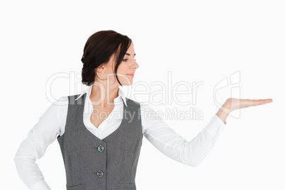 Young businesswoman looking at her palm facing up