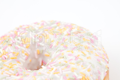 Close up on doughnut with multi coloured icing sugar