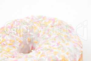 Close up on doughnut with multi coloured icing sugar