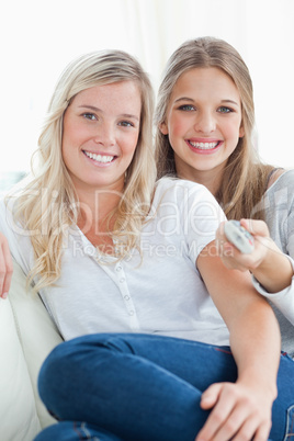 Close up of laughing sisters sitting on the couch