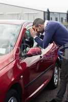 Man looking through the window of the car