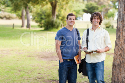 Portrait of two standing male students talking