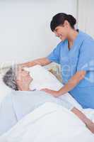 Nurse touching the shoulder of a patient