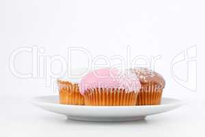 Muffins with icing sugar on a white plate