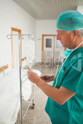 Surgeon measuring an intravenous drip