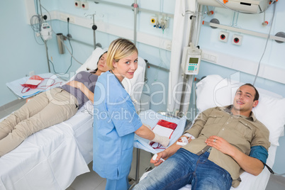 Transfused patients and a nurse looking at camera