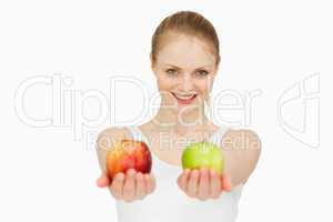 Smiling woman presenting two apples