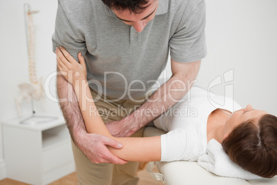 Woman lying while being massaged